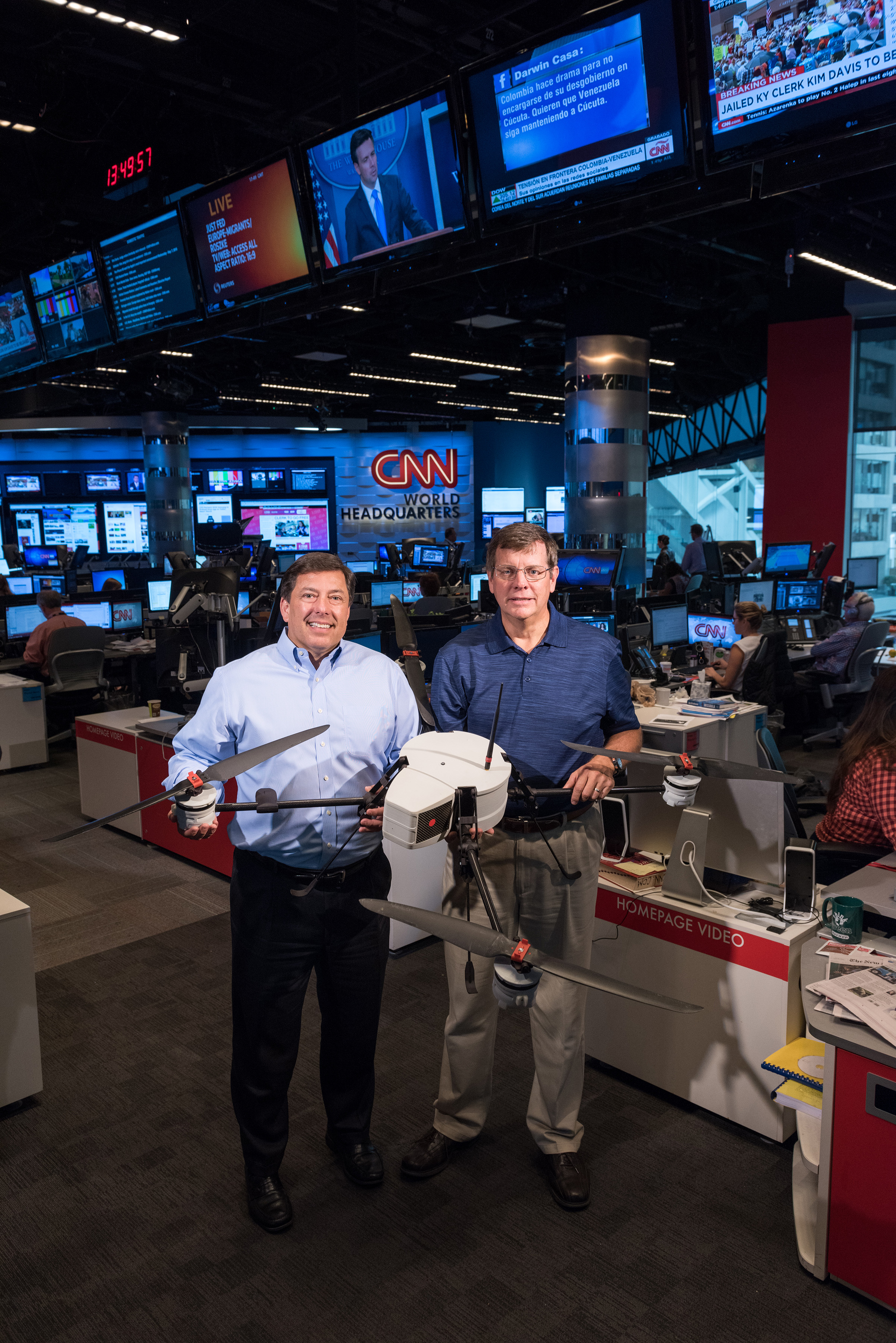 Shown in CNN’s World Headquarters are (left) Greg Agvent, senior director of news operations for CNN, and Cliff Eckert, a GTRI senior research associate. They are working with an AirRobot AR 180 (Credit: Rob Felt, Georgia Tech)