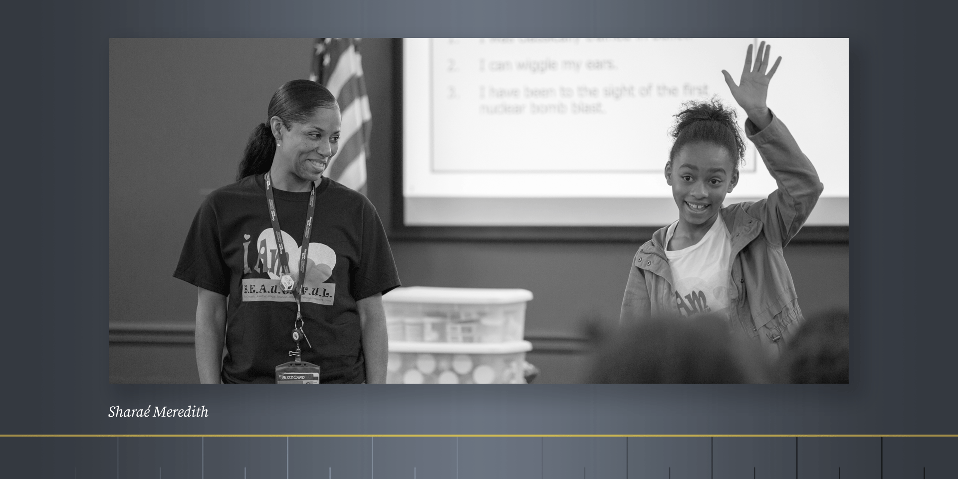 Black and white photo of young woman in a classroom.