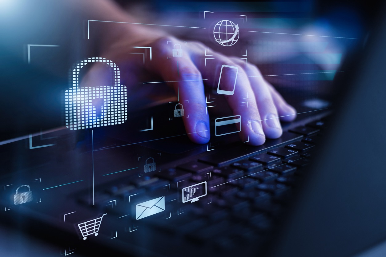 Closeup view of man`s hand using laptop with virtual digital screen with icon of lock on it. (Credit: Traitov, iStockphoto.com)