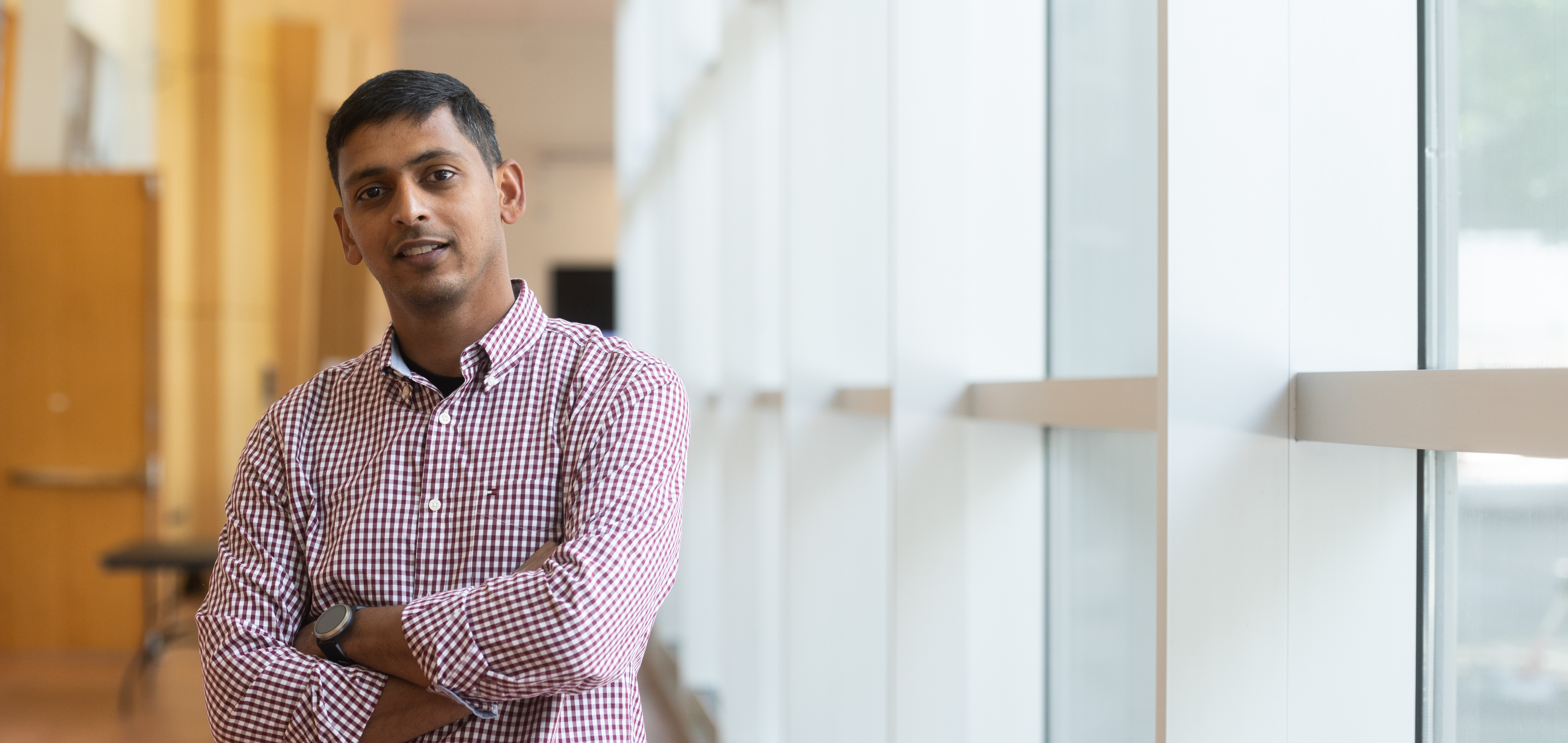 William Benjamin, a research engineer II at the Georgia Tech Research Institute, posing near a window in Coda building in Atlanta, Georgia. (Credit: Allison Carter)