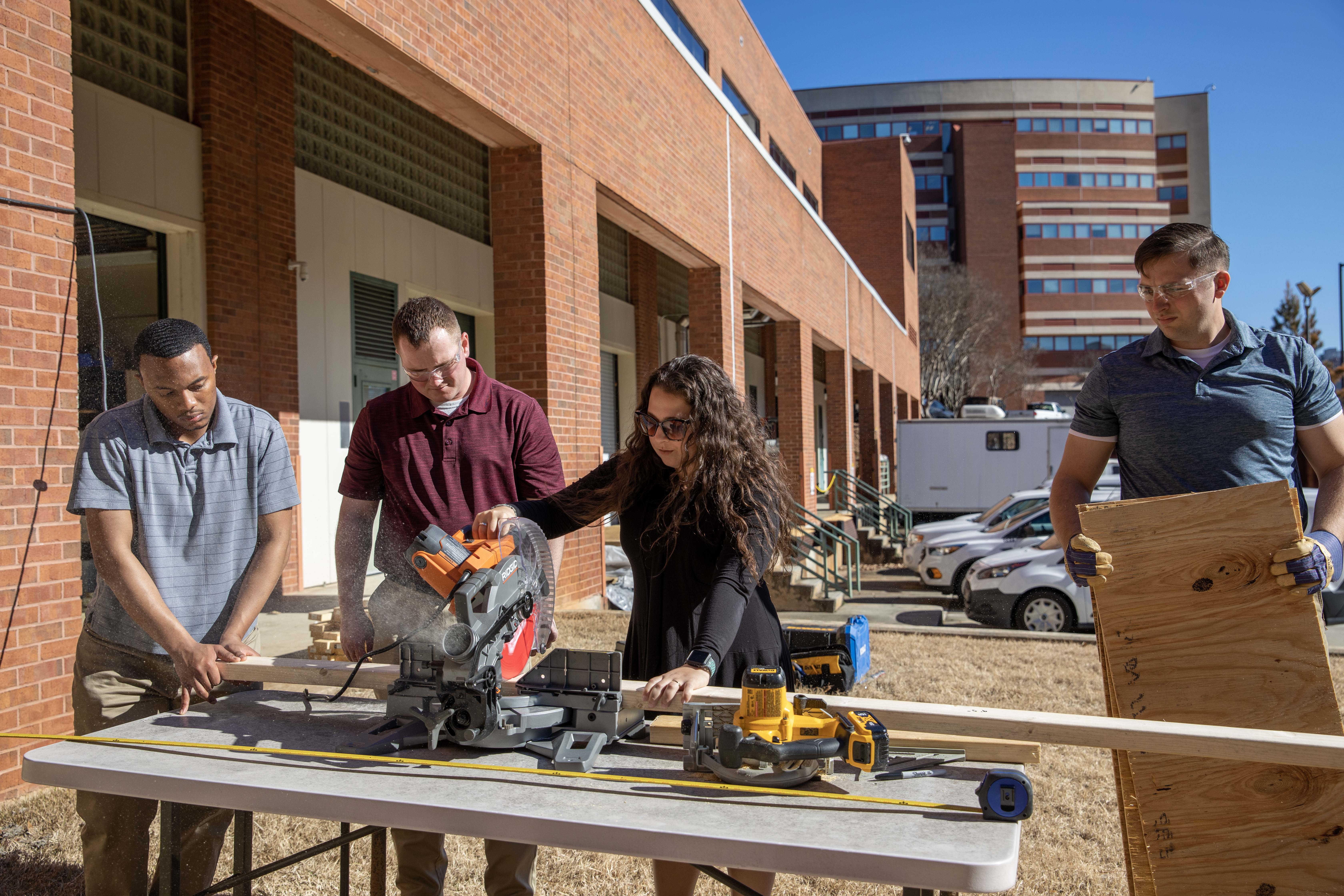 Participant Danielle Shutt uses a saw to help her team build a decoy.