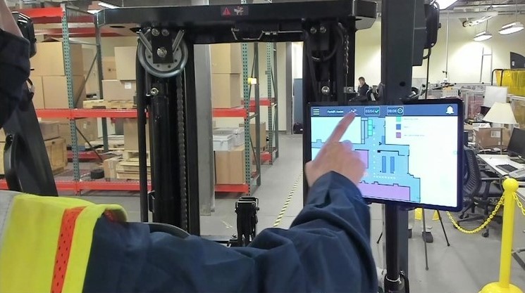 A photo of a forklift driver using GTRI's Real-time Intelligent Fusion Service. 