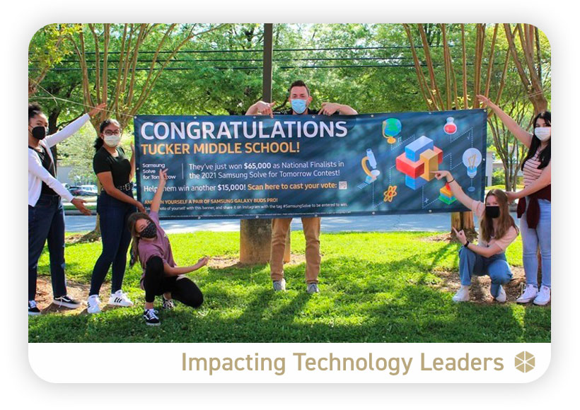 Tucker Middle School students standing with school banner