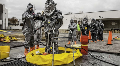 two people in chemical suits